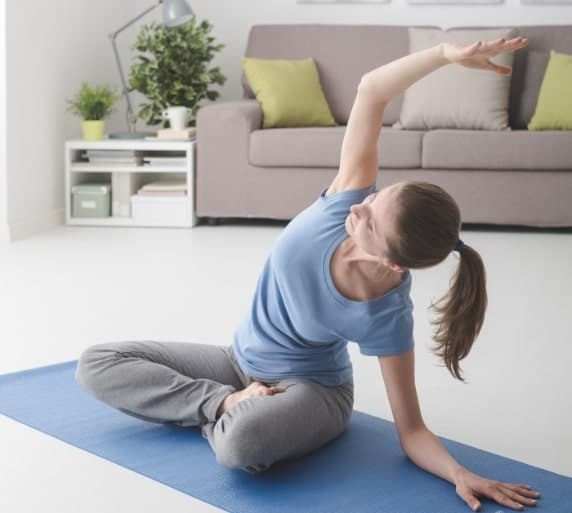 woman practicing yoga at home Naturheilpraxis Aachen