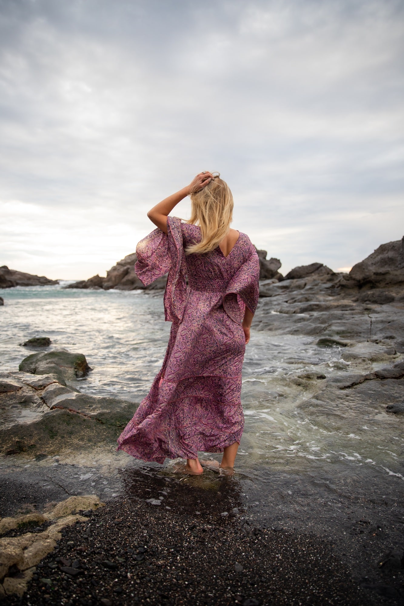girl at the beach observes the ocean, relaxation and meditation concepts.